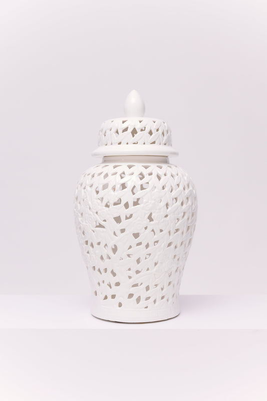 This elegant white porcelain ginger jar features a finely reticulated (pierced) lattice design, creating a delicate interplay of light and shadow. The body is adorned with sculpted floral and branch motifs worked seamlessly into the openwork pattern, adding depth and refinement. Topped with a domed lid and finial, the piece embodies a timeless chinoiserie aesthetic.