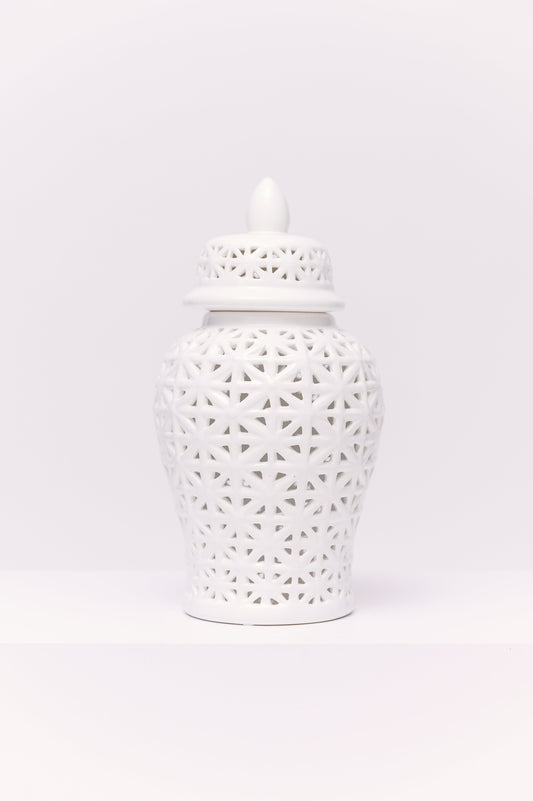 This elegant white porcelain ginger jar features a reticulated (pierced) geometric lattice design, giving it a delicate, airy quality. The pattern, formed by interlocking star-like shapes, allows light to filter through, creating subtle shadows and dimension. Finished with a matching pierced lid and pointed finial, the jar is a timeless decorative accent with a clean, modern chinoiserie appeal.