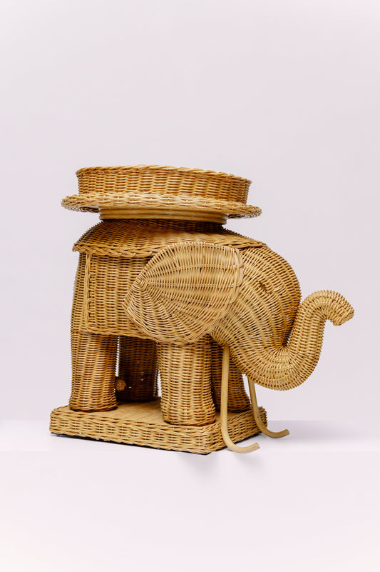 Wicker elephant-shaped side table on a white background